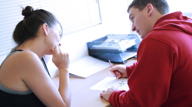 Personal_trainer_assessing_a_client's_goals_and_needs_as_they_write_a_fitness_programme Personal_trainer_assessing_a_client's_goals_and_needs_as_they_write_a_fitness_programme