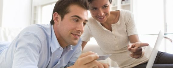 Couple using credit card to shop online