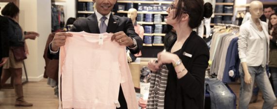 President Barack Obama looks at a sweater with Gap employee Susan Panariello while shopping for his family in New York