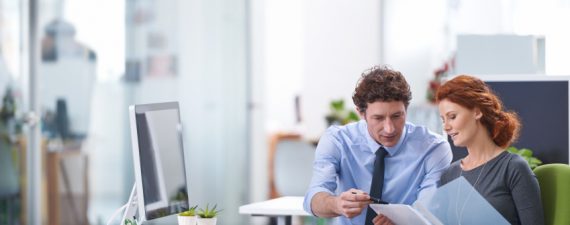 Young business professionals discussing work documents