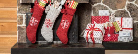 Stuffed stockings hanging on a fireplace on christmas morning