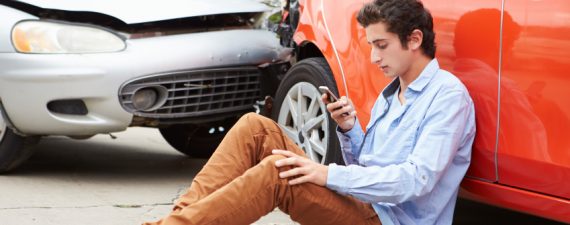 Teenage Driver Making Phone Call After Traffic Accident