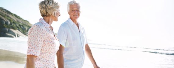 Shot of a senior couple walking on the beach