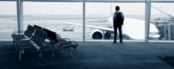 Businessman waiting for his departure in the airport lounge