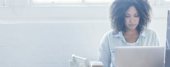 Woman working on a laptop.