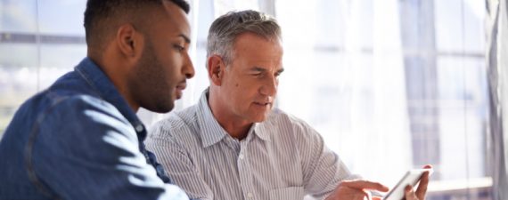 Shot of two colleagues working together in an informal office setting