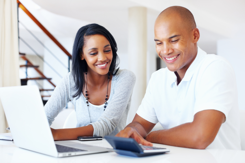 Portrait of African American couple going over their monthly expenses