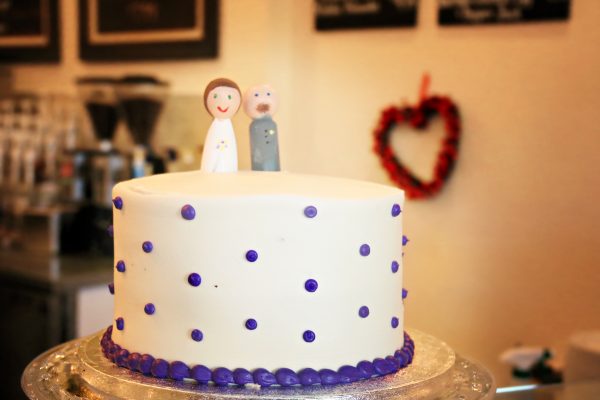 The Verlegers bought a cake and cupcakes from a high-end grocery store. Brittany made the cake toppers in the couple’s likeness. Total dessert costs: $60.